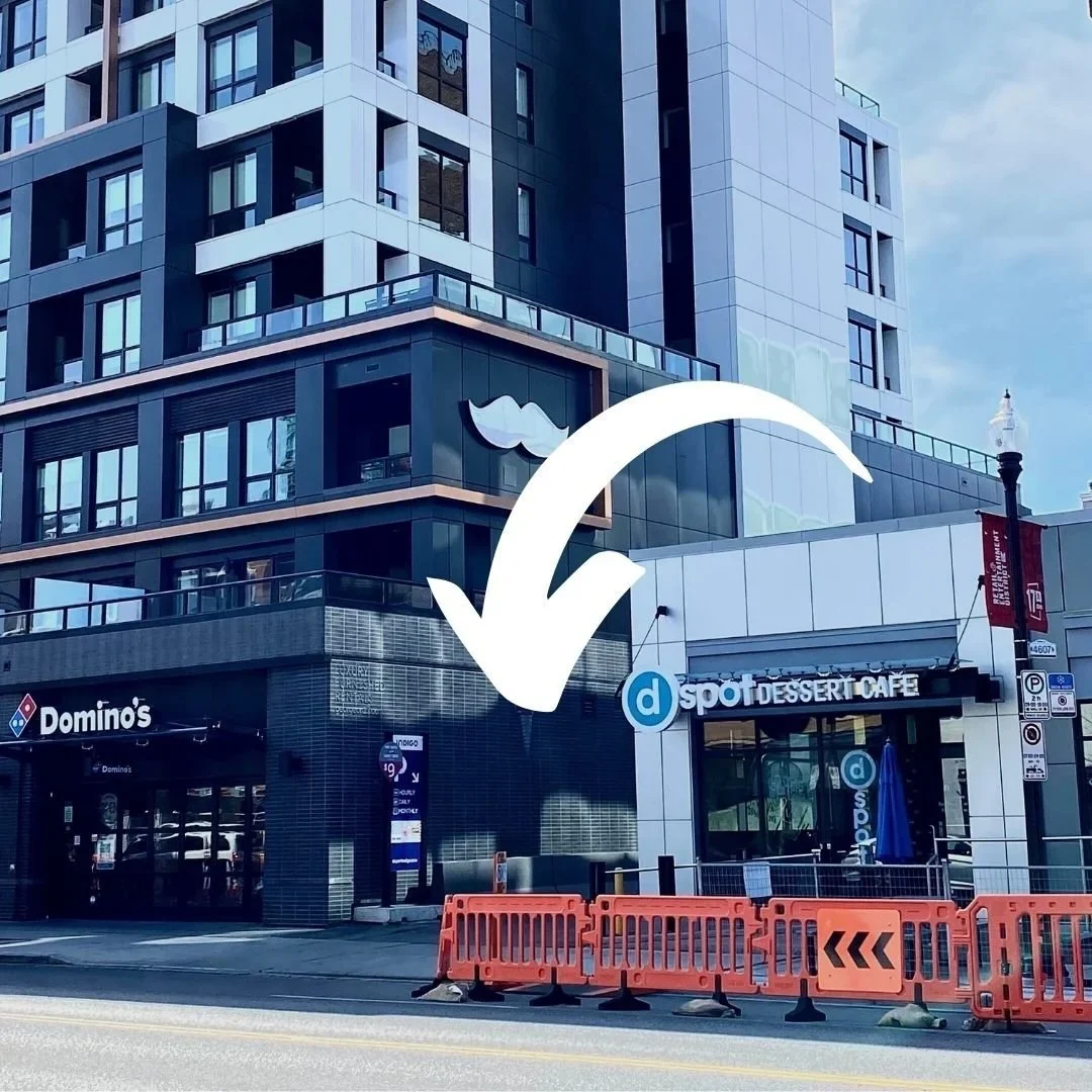 Street view showing the INDIGO parking entrance between Domino's and D Spot Dessert Cafe